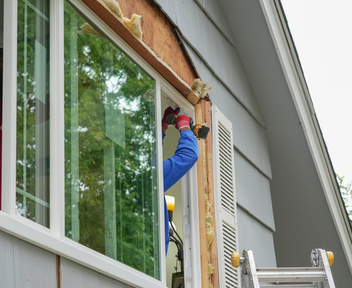 Contractor replacing a residential window