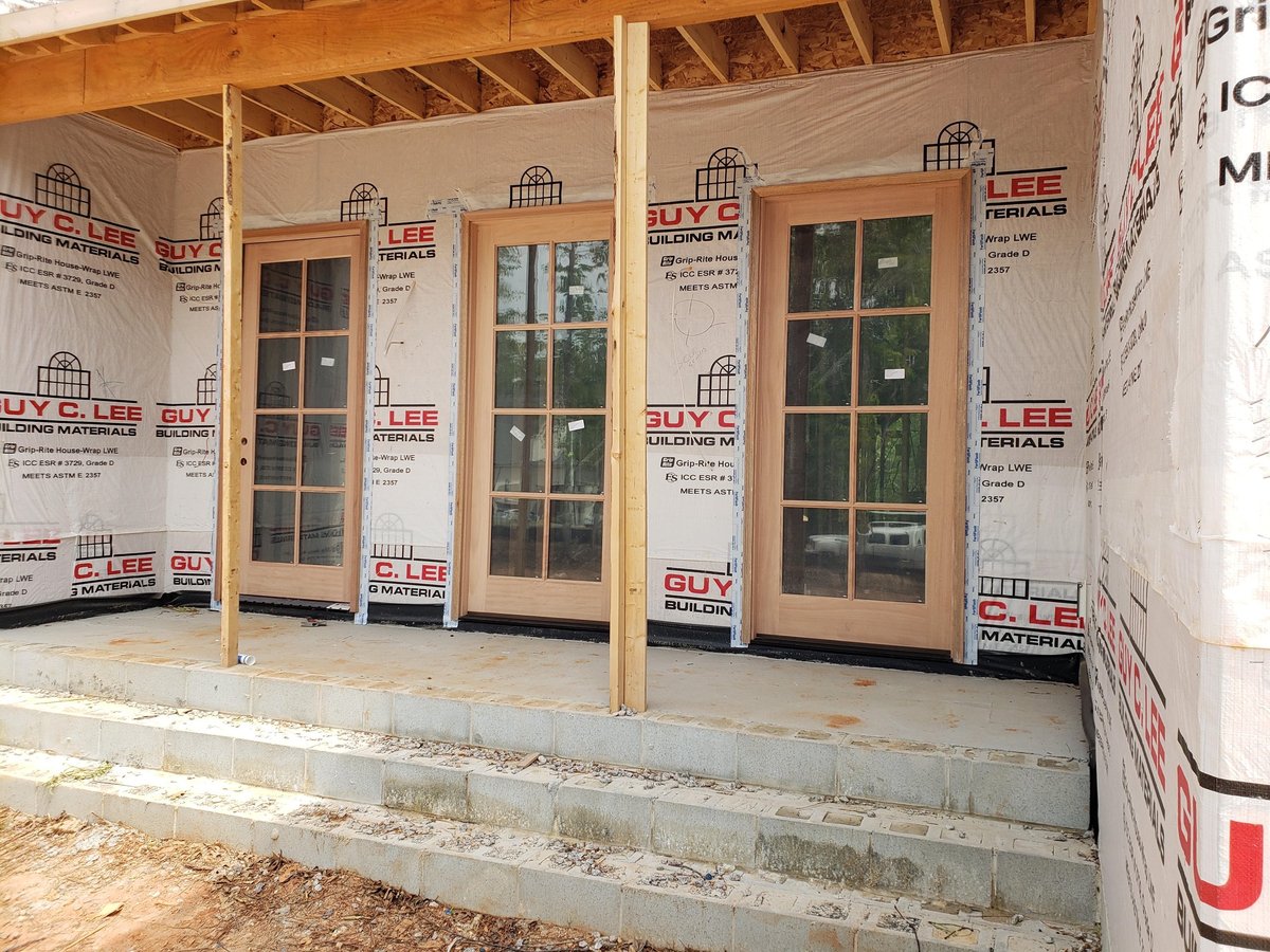 Three glass patio doors installed on a concrete foundation